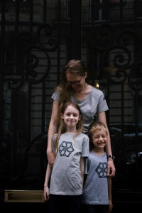 Two children and their mother wearing the NWC Ed.6 grey event t-shirt